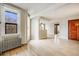 Bright and airy living room with hardwood floors, radiator, and open floor plan at 215 E 11Th Ave # C3, Denver, CO 80203
