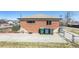 Back of brick home featuring a fenced yard with recycling bins at 10454 Grant Dr, Northglenn, CO 80233