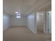 Spacious carpeted basement with neutral paint, providing a versatile living space at 10454 Grant Dr, Northglenn, CO 80233