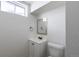 Clean bathroom features white vanity, mirror, toilet, and a small window at 10454 Grant Dr, Northglenn, CO 80233