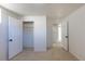 Light-filled bedroom with neutral carpet, open closet, and multiple doorways at 10454 Grant Dr, Northglenn, CO 80233