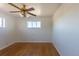 Bright bedroom featuring hardwood floors, a ceiling fan, and a window at 10454 Grant Dr, Northglenn, CO 80233