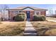 Brick home with a well-kept lawn and landscaping, showcasing curb appeal at 10454 Grant Dr, Northglenn, CO 80233