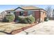 Brick home with a well-kept lawn and landscaping, showcasing curb appeal at 10454 Grant Dr, Northglenn, CO 80233