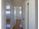 Hallway with wooden floors showing doors to multiple rooms at 10454 Grant Dr, Northglenn, CO 80233