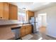 Traditional kitchen featuring wood cabinetry, stainless steel appliances, and a double sink at 10454 Grant Dr, Northglenn, CO 80233