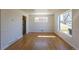 Bright living room with hardwood floors and lots of natural light from the large windows at 10454 Grant Dr, Northglenn, CO 80233