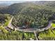 Stunning aerial view of the home nestled among lush green trees, showcasing its serene and private location at 27383 Highway 74, Evergreen, CO 80439