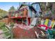 Charming home with a deck and colorful accents, surrounded by landscaping, and outdoor recreational items at 27383 Highway 74, Evergreen, CO 80439