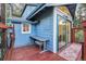 Exterior view featuring a blue house with a deck, bench seating, and sliding glass door entrance at 27383 Highway 74, Evergreen, CO 80439