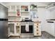 Cozy kitchen with stainless steel oven and stove, open white shelving and butcher block counter at 27383 Highway 74, Evergreen, CO 80439