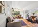 Bright living room with wood floors, large windows, and vaulted ceilings creating a welcoming atmosphere at 27383 Highway 74, Evergreen, CO 80439