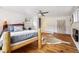 Spacious main bedroom with hardwood floors, rustic bed, and ample natural light throughout at 27383 Highway 74, Evergreen, CO 80439