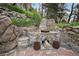 Rustic outdoor grill area constructed with stone, offering a unique and inviting space for cooking and entertaining at 27383 Highway 74, Evergreen, CO 80439