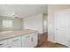 Open kitchen with island, white cabinets, stainless hardware, flowing into the living area at 48275 Shetland Dr, Bennett, CO 80102