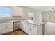 Functional kitchen with white cabinets, stainless steel dishwasher, and a spacious island, ideal for food preparation at 48275 Shetland Dr, Bennett, CO 80102