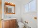 Clean bathroom with a single sink vanity and natural wood accents at 343 Melody Dr, Northglenn, CO 80260