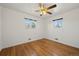 Bright bedroom featuring hardwood floors and dual windows at 343 Melody Dr, Northglenn, CO 80260