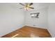 Bright bedroom featuring hardwood floors, white walls, a ceiling fan, and a window for natural light at 343 Melody Dr, Northglenn, CO 80260