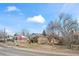 A single-Gathering home featuring brick accents, a stop sign, and a clear blue sky at 343 Melody Dr, Northglenn, CO 80260