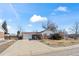 Single-Gathering home featuring brick accents, a well-maintained lawn, and a spacious two-car garage at 343 Melody Dr, Northglenn, CO 80260