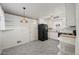 Cozy kitchen featuring marble floors, a black refrigerator, and bright white cabinets at 343 Melody Dr, Northglenn, CO 80260