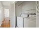 Convenient laundry area with washer, dryer, and storage shelves at 343 Melody Dr, Northglenn, CO 80260