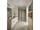 Bright bathroom with double vanity, framed mirror, updated shower with glass doors, and stylish towel racks at 6153 N Ceylon St # 305, Denver, CO 80249