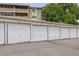 Row of garages with white doors for convenient resident parking at condo complex at 650 S Alton Way # 10A, Denver, CO 80247