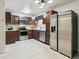 Updated kitchen features wood cabinets, stainless appliances, tile backsplash, and granite counters at 650 S Alton Way # 10A, Denver, CO 80247
