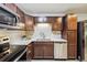 Updated kitchen features wood cabinets, stainless appliances, tile backsplash, and granite counters at 650 S Alton Way # 10A, Denver, CO 80247