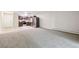 Open-concept living space with a fully renovated kitchen and newer carpet throughout the unit at 650 S Alton Way # 10A, Denver, CO 80247
