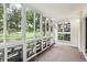 The sunroom offers large windows with expansive green outdoor views and a private entry at 650 S Alton Way # 10A, Denver, CO 80247