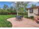Spacious backyard featuring mature trees, green grass and an outdoor dining area at 10165 W Iowa Ave, Lakewood, CO 80232