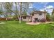 Large grassy yard with a stone patio, perfect for outdoor entertaining and relaxation at 10165 W Iowa Ave, Lakewood, CO 80232