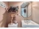 Charming powder room with decorative wallpaper, octagonal mirror and modern fixtures at 10165 W Iowa Ave, Lakewood, CO 80232