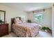 Cozy bedroom with floral bedding, natural light and a decorative mirror at 10165 W Iowa Ave, Lakewood, CO 80232