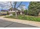 Beautiful two-story home with well-kept lawn and mature landscaping at 10165 W Iowa Ave, Lakewood, CO 80232
