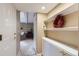 Hallway with white cabinets, open shelving and a glimpse into the living room at 10165 W Iowa Ave, Lakewood, CO 80232