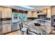Kitchen with a granite island, stainless steel appliances, light cabinetry, and a skylight at 10165 W Iowa Ave, Lakewood, CO 80232