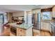 Open kitchen with a large central island, stainless steel fridge and access to the dining room at 10165 W Iowa Ave, Lakewood, CO 80232