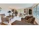 Bright and airy living room featuring neutral tones, plush seating, and large windows for natural light at 10165 W Iowa Ave, Lakewood, CO 80232