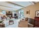 Bright living room with a brick fireplace, access to the backyard, and neutral decor at 10165 W Iowa Ave, Lakewood, CO 80232