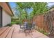 Outdoor patio with a metal table and chairs and mature landscape at 10165 W Iowa Ave, Lakewood, CO 80232