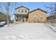 Two-story house with stone and siding exterior, snowy front yard at 3587 Vestal Loop, Broomfield, CO 80023