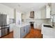 Modern kitchen with white cabinets, marble island, and stainless steel appliances at 3587 Vestal Loop, Broomfield, CO 80023