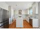 Modern kitchen with white cabinets, marble counters, and stainless steel appliances at 3587 Vestal Loop, Broomfield, CO 80023