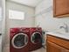 Laundry room with washer, dryer, sink and cabinets at 3587 Vestal Loop, Broomfield, CO 80023