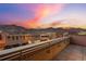 Balcony view overlooking downtown with a railing, stunning sunset and mountain backdrop at 1275 Washington Ave, Golden, CO 80401
