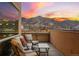 Cozy balcony with cushioned seating offers mountain views and colorful sunrise backdrop at 1275 Washington Ave, Golden, CO 80401